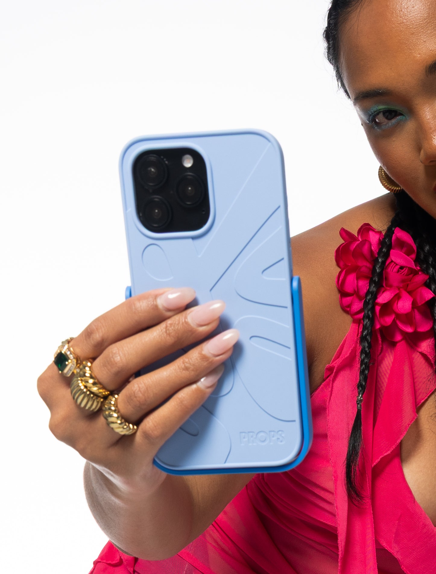 Person holding a blue PROPS phone case with a white background