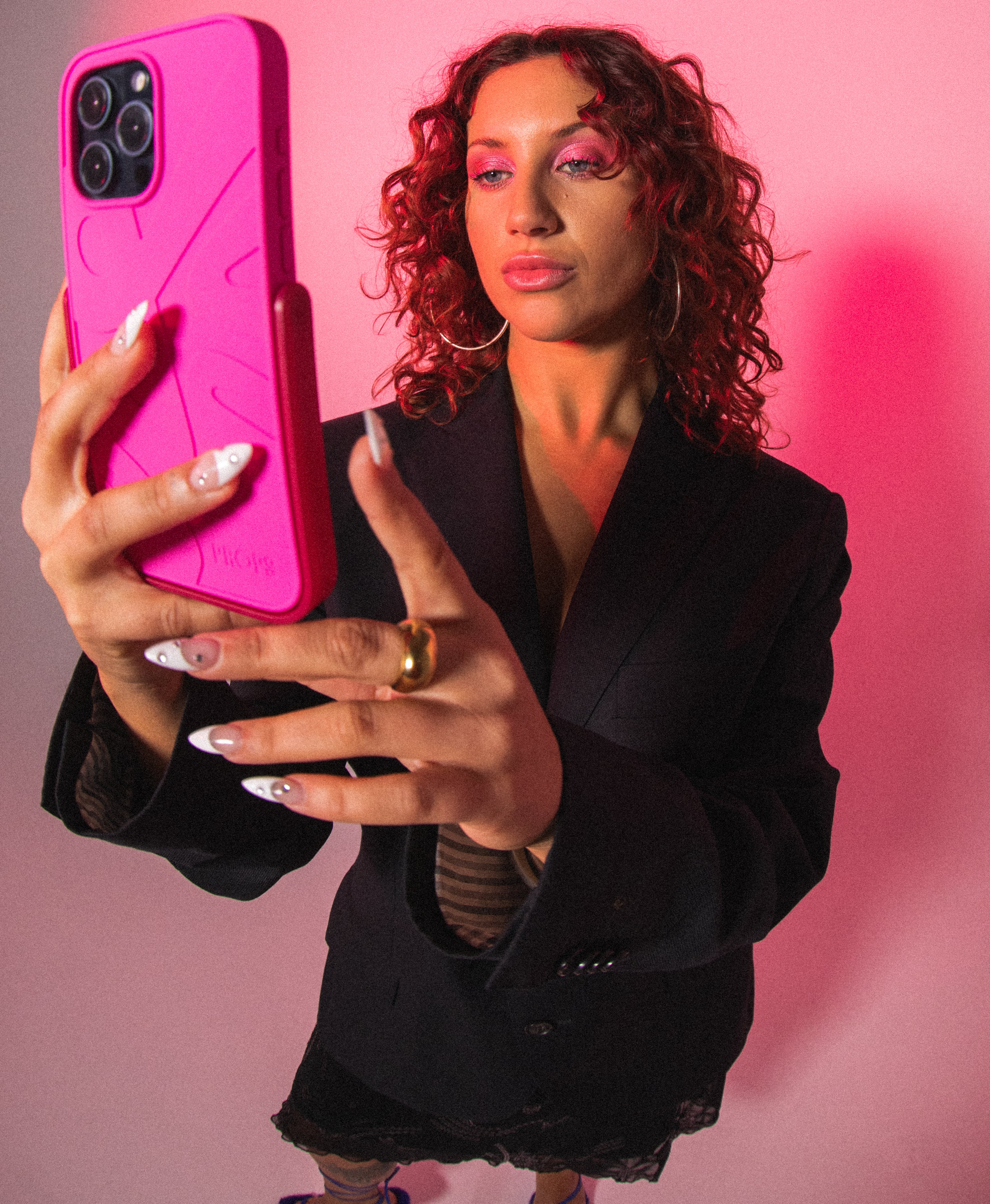 Fashionable girl holding bright pink phone case with built in stand