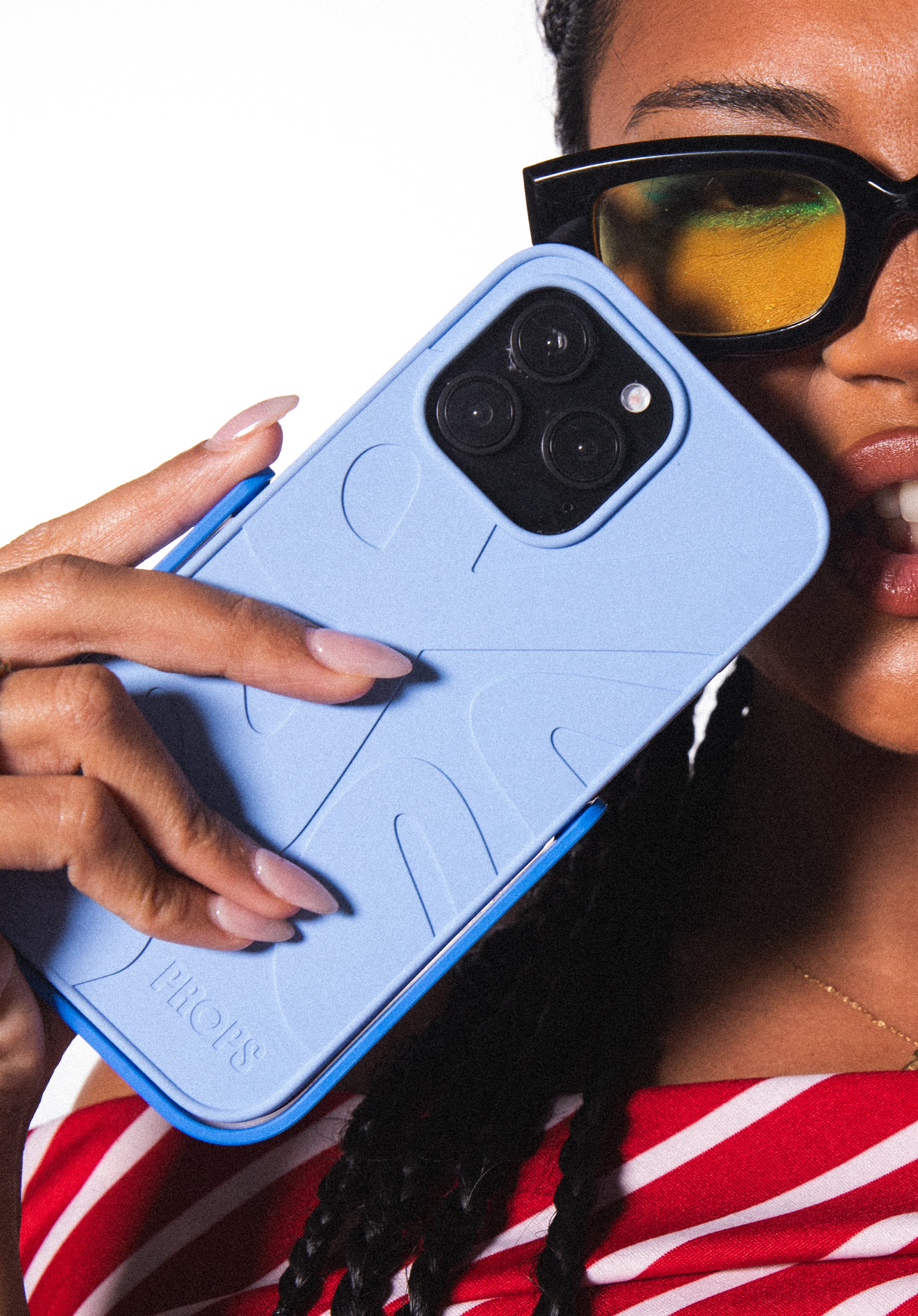 Person holding a blue phone case with PROPS branding