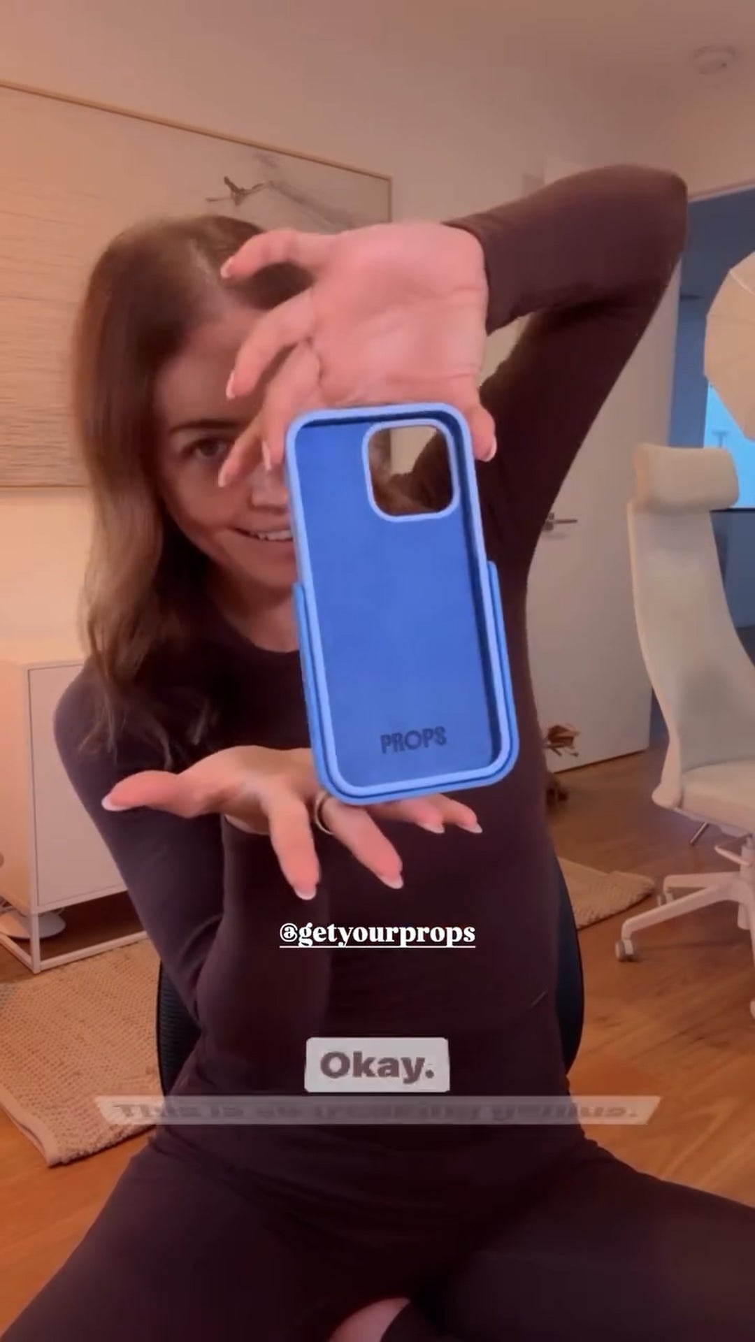 Chani Peach holds up the PROPS iphone case