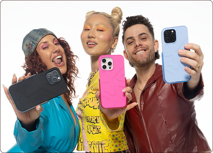 Three people holding up smartphones with colorful phone cases against a white background